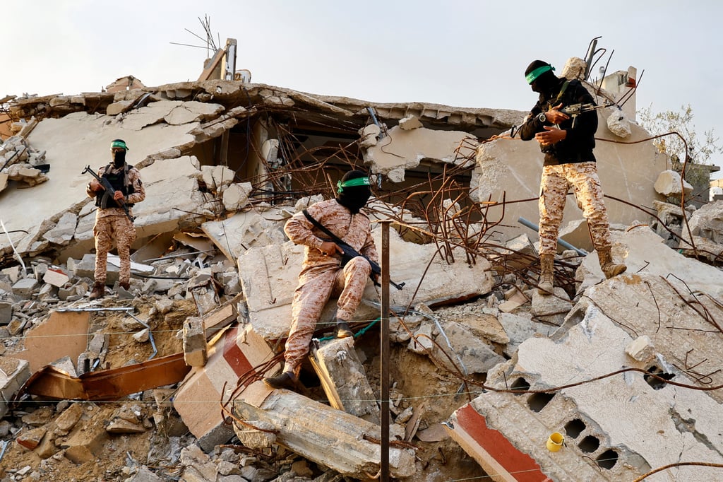 Palestinian Hamas militants stand amid the rubble of Khan Younis in the southern Gaza Strip on Thursday. Photo: Reuters