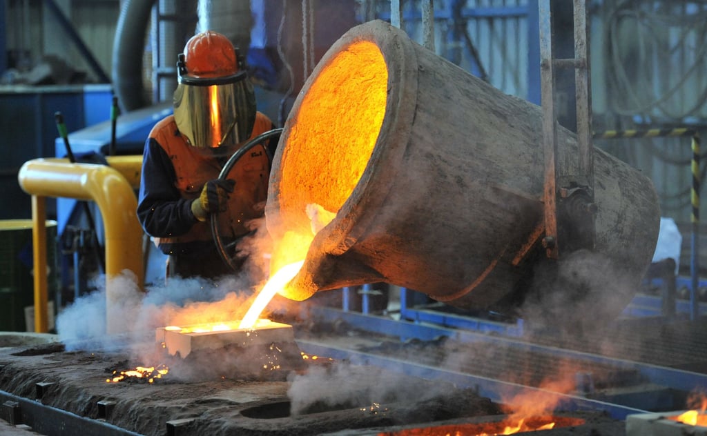 A worker pours molten iron at a factory in Geelong, Australia. Photo: EPA-EFE