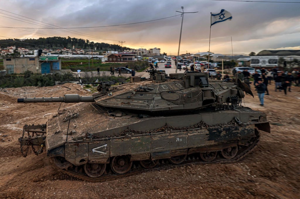 People look on as Israeli tanks enter the Jenin camp for Palestinian refugees. Photo: AFP