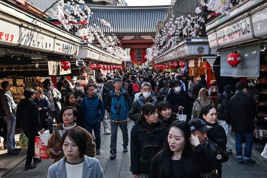 People walk along the main shopping street at Sensoji Temple in the popular tourist destination of Asakusa in central Tokyo. Photo: AFP
