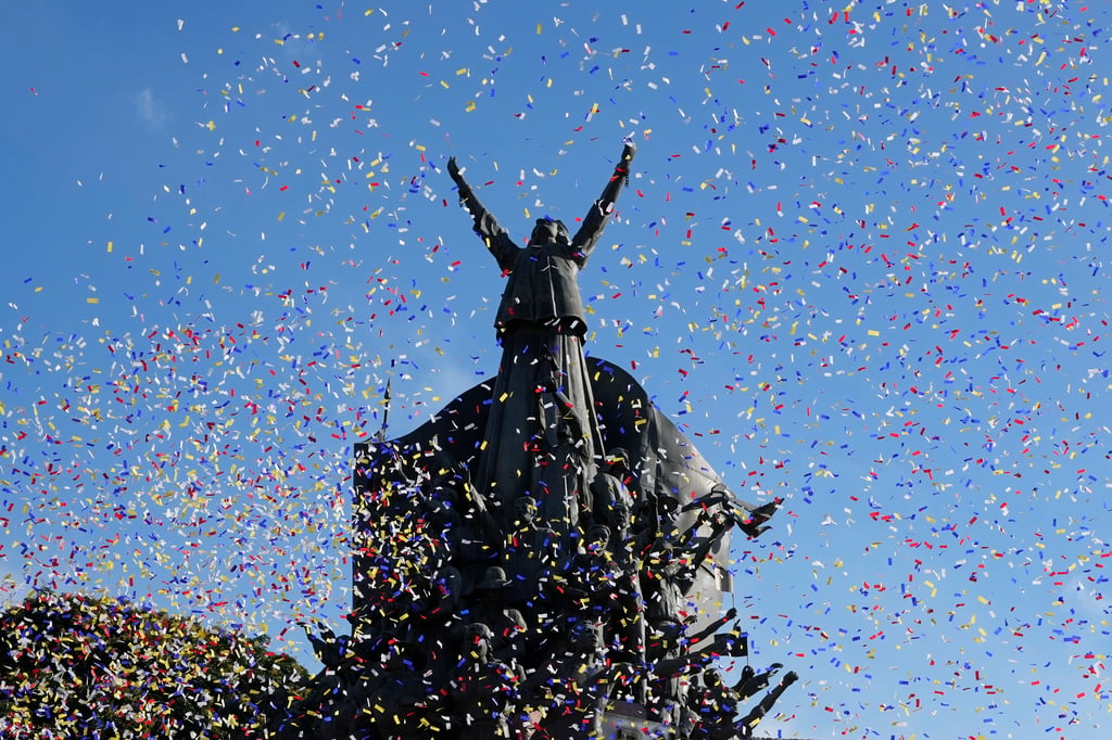 Confetti falls during celebrations in Quezon City on February 20 for the 39th anniversary of the near-bloodless coup that ousted the late Philippine dictator Ferdinand Marcos. Photo: AP