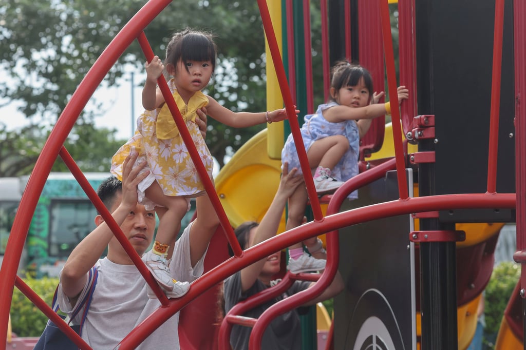 Parents hold up their children as they play at Sun Yat-sen Memorial Park, on August 10, 2024. Photo: Edmond So.