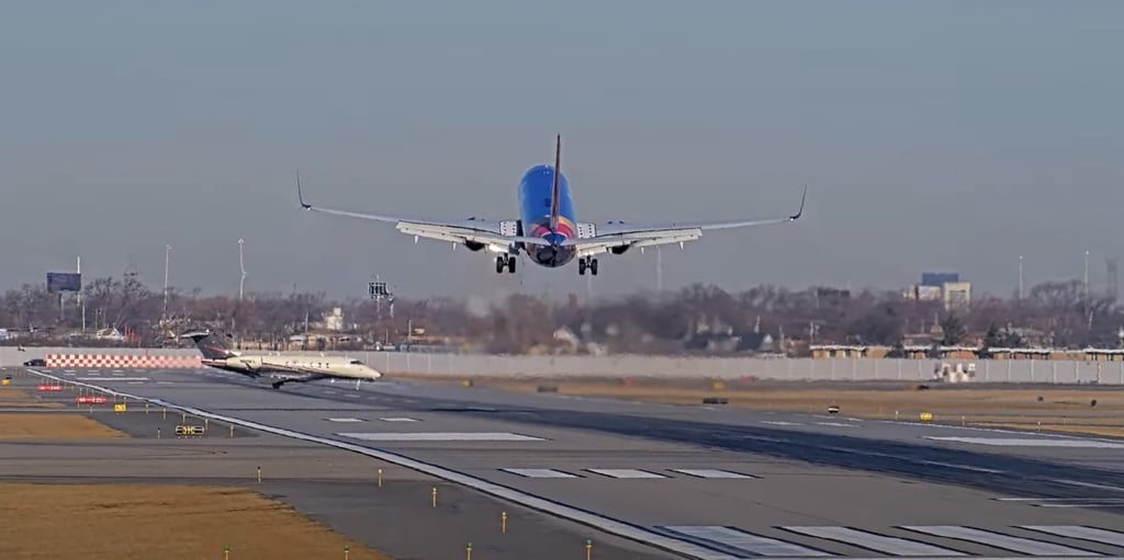 A smaller jet crosses the runway that a passenger plane was set to use in Chicago on Tuesday. Photo: StreamTime LIVE via YouTube