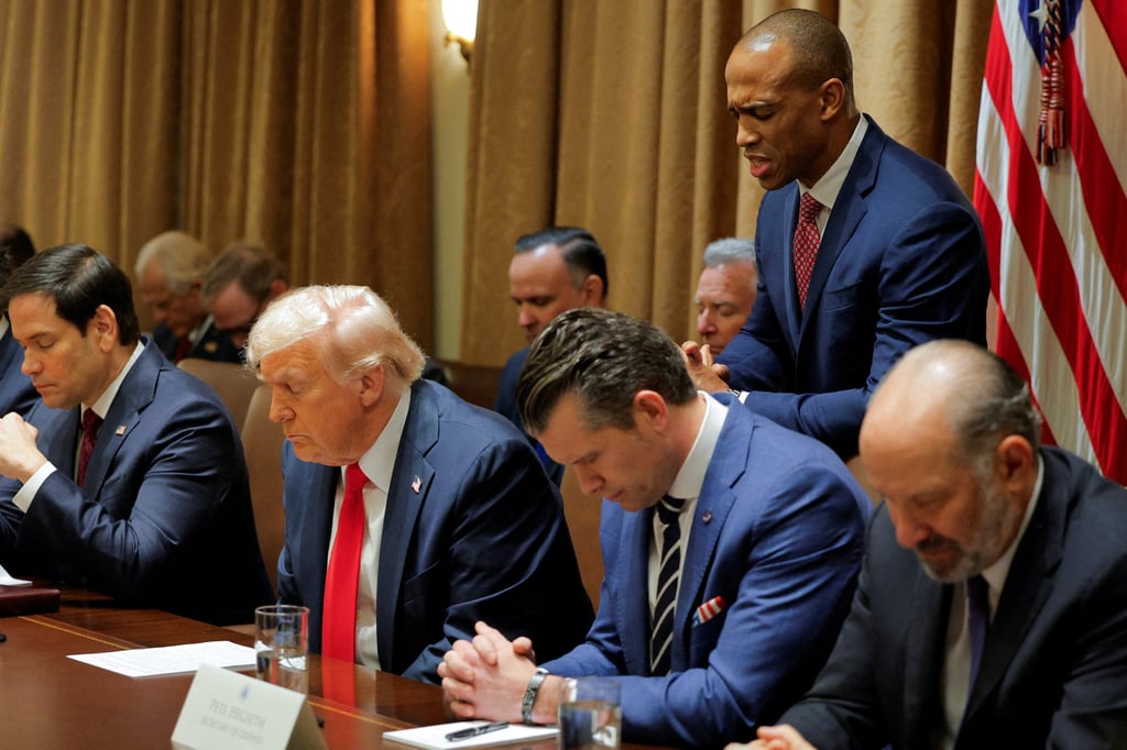 US Secretary of Housing and Urban Development Scott Turner leads a prayer. Photo: Reuters