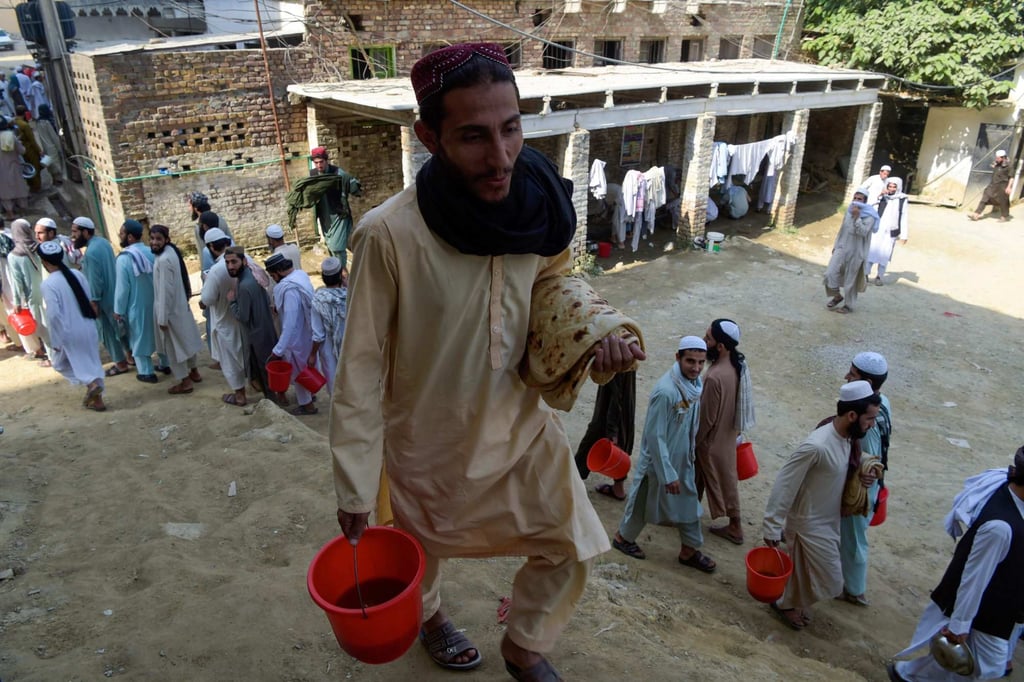 Students wait to collect food at the Dar-ul-Uloom Haqqania school in Akora Khattak. Photo: AFP