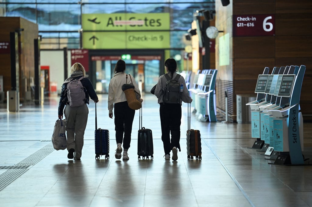 Passengers walk past self check-in kiosks at Berlin airport. Photo: Reuters