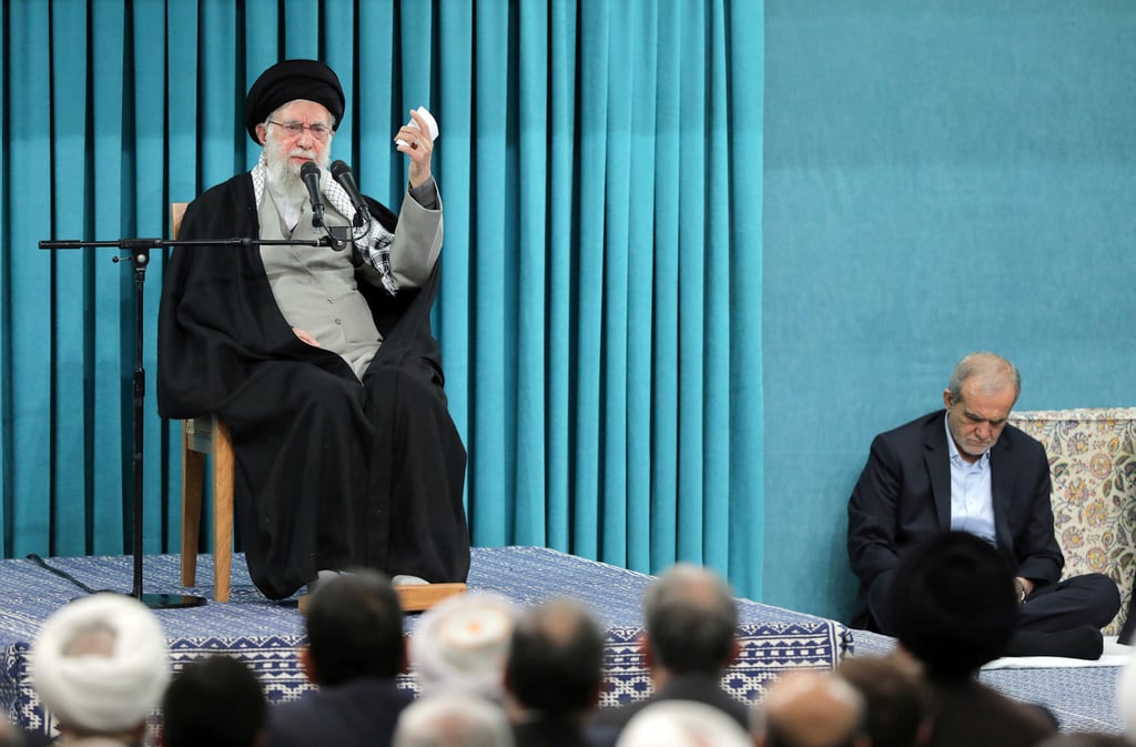 Iran’s Supreme Leader Ayatollah Khamenei speaks at a meeting in Tehran on Saturday as President Masoud Pezeshkian listens. Photo: Office of the Iranian Supreme Leader via AP