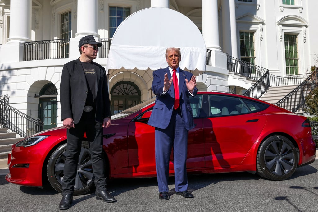 US President Donald Trump (centre) talks to the media next to Tesla CEO Elon Musk at the White House on Tuesday. Photo: Reuters,