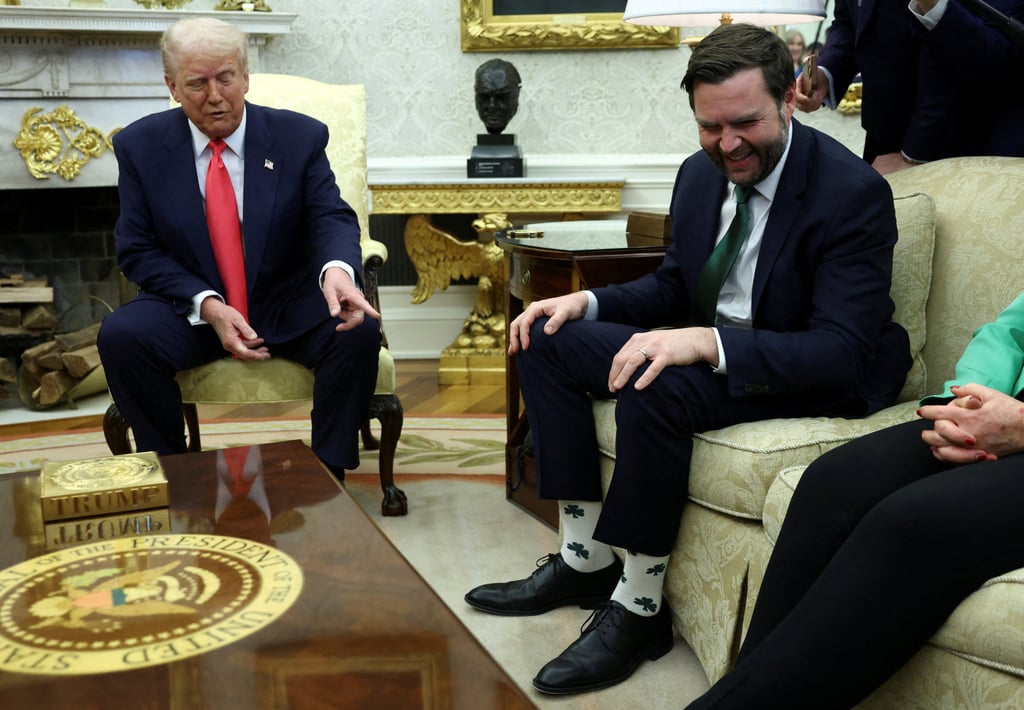 US President Donald Trump points at US Vice-President J.D. Vance’s socks. Photo: Reuters
