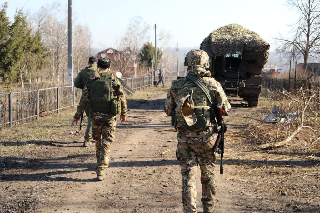 Russian service members on Friday walk along a street in the Kursk region, which was recently retaken by the Kremlin’s armed forces in the Ukraine war. Photo: Reuters