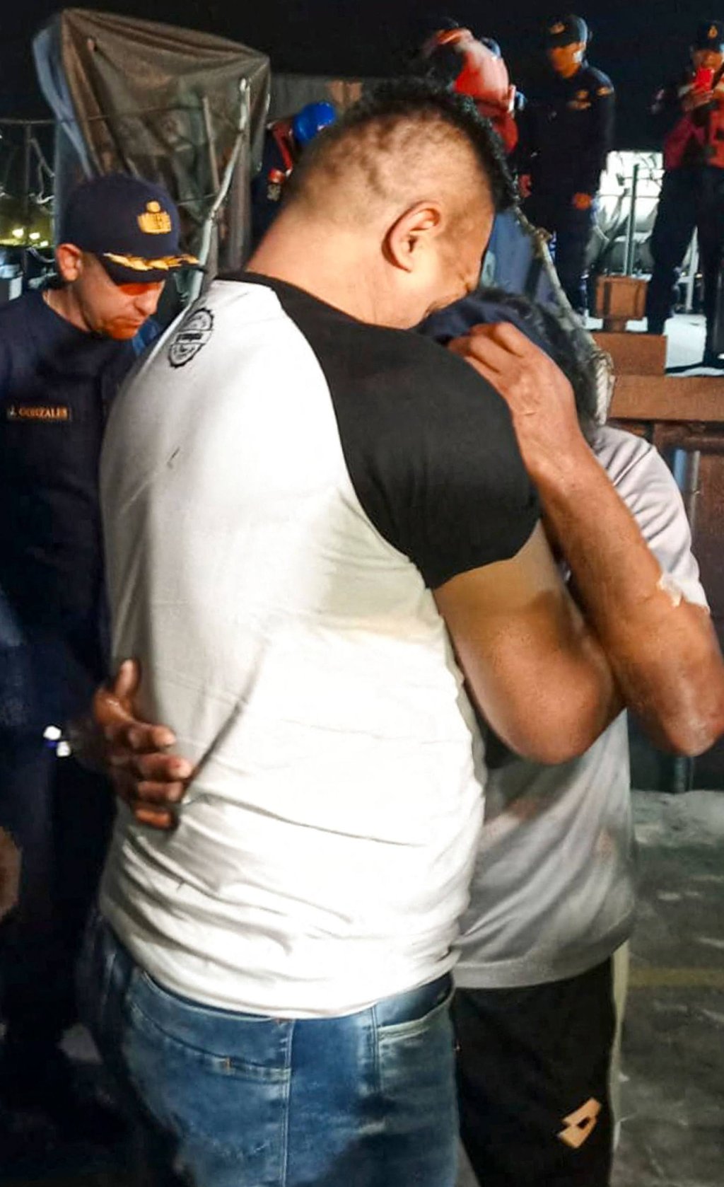 Peruvian fisherman Maximo Napa (right), is greeted by his brother upon his arrival in Paita in a handout photo released on Friday. Photo: AFP/Peruvian Navy