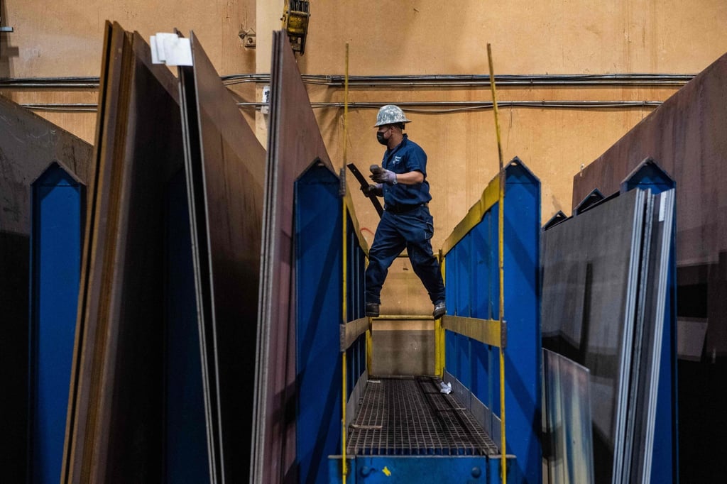 A worker manoeuvres around steel sheets at Central Steel Supply Company in Marlborough, Massachusetts on March 13. Trump had threatened to double incoming steel and aluminium tariffs on Canadian imports from 25 per cent to 50 per cent but pulled back from imposing the additional tariffs a day later. Photo: AFP