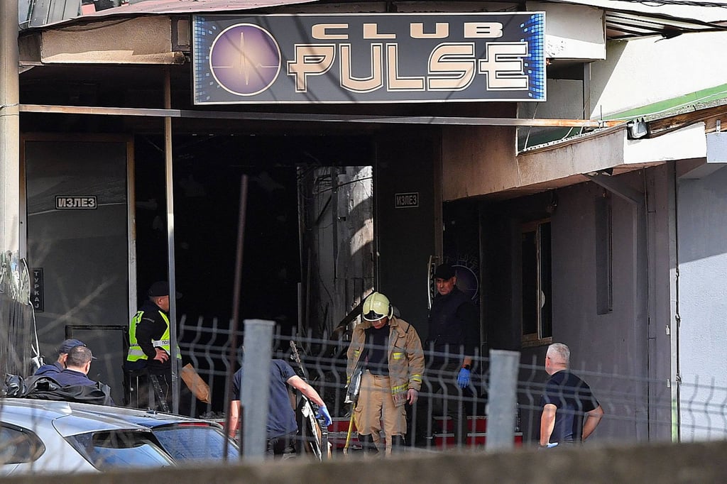 Firefighters and police officers at the scene. Photo: AFP