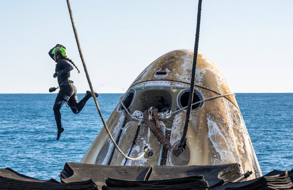 Support teams work around a SpaceX Dragon spacecraft shortly after it landed. Photo: Nasa/Keegan Barber via Reuters