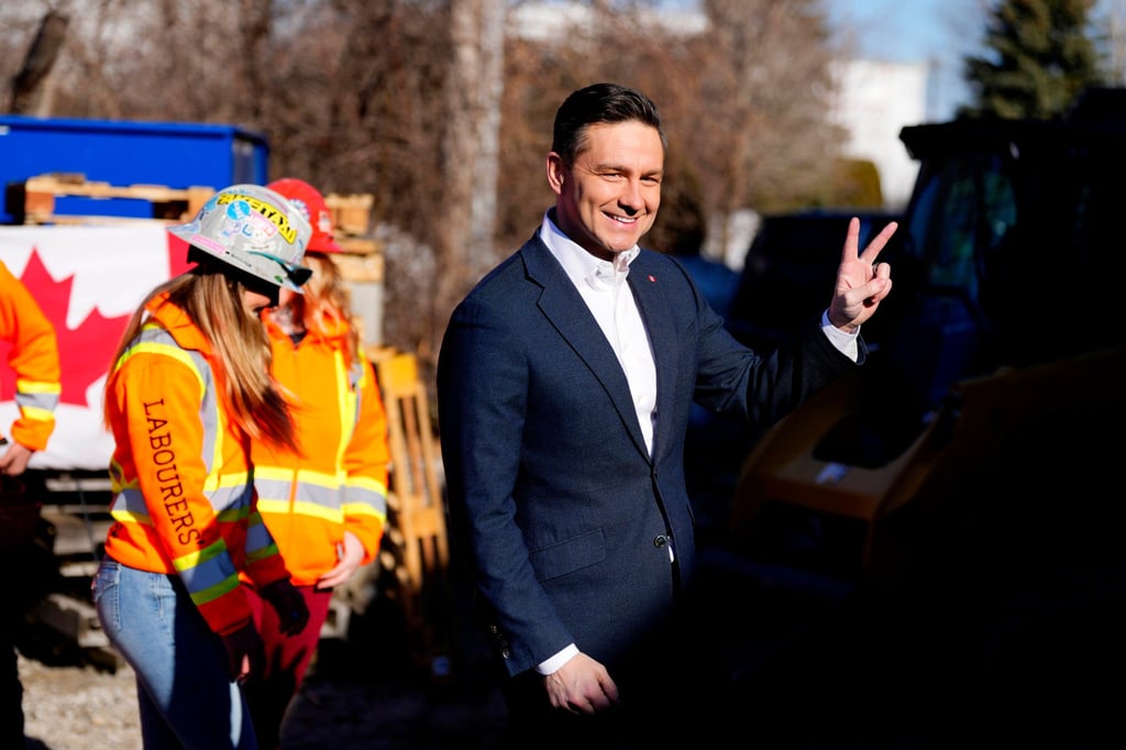 Conservative Leader Pierre Poilievre gestures towards the cameras after greeting and handing out doughnuts to members at a labour union’s training centre, on Friday. Photo: Canadian Press/AP