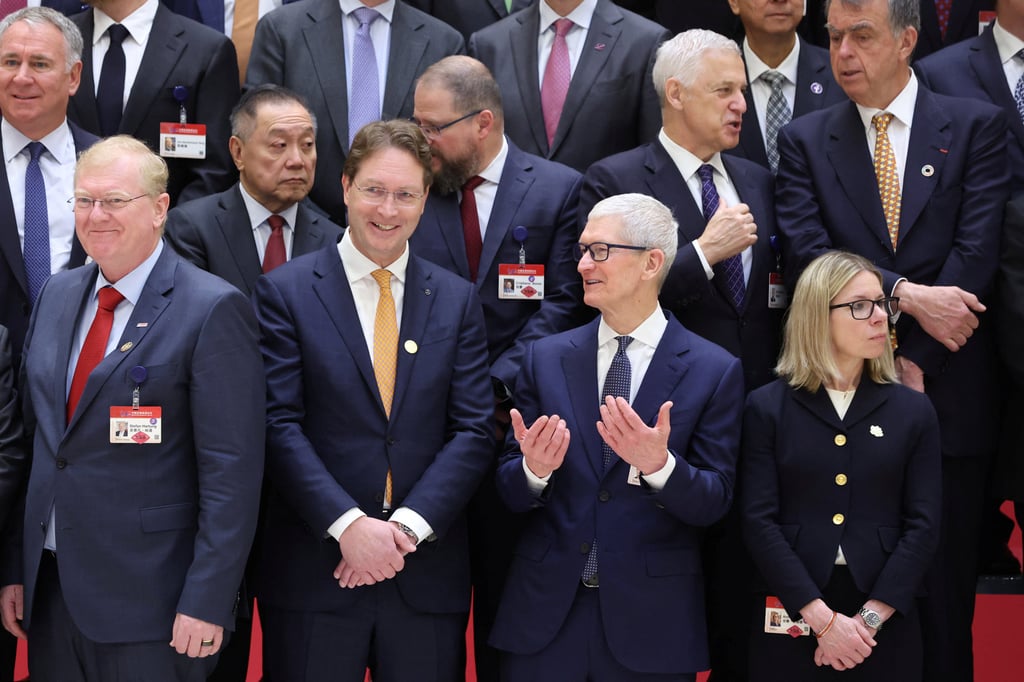 Apple CEO Tim Cook chats with other attendees before the opening ceremony of the China Development Forum in Beijing on March 23. Photo: via Reuters