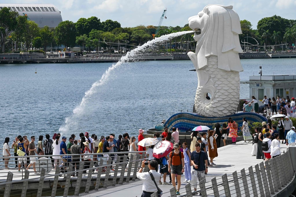 Tourists visit the Merlion statue on Singapore’s Marina Bay waterfront earlier this month. Photo: AFP