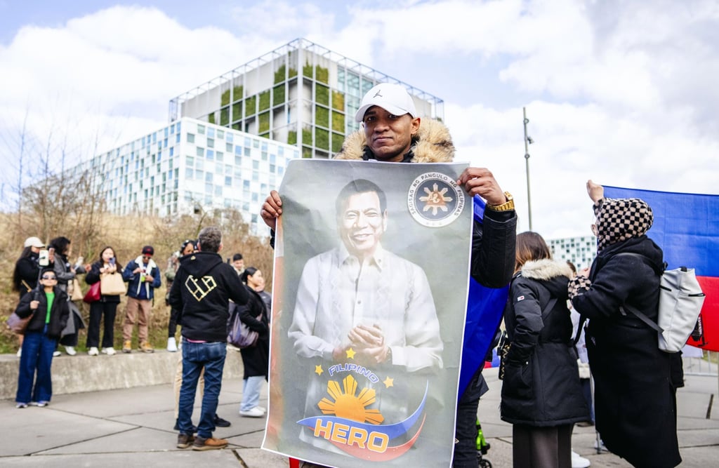 A supporter of former Philippine president Rodrigo Duterte displays his portrait as they gather in front of the International Criminal Court (ICC) in The Hague, The Netherlands, on March 14. Photo: EPA-EFE