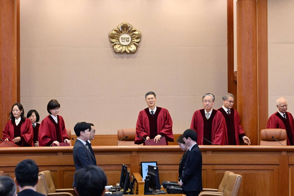 The acting chief justice of South Korea’s Constitutional Court, Moon Hyung-bae (fourth from right), and other judges arrive for Han’s impeachment verdict on Monday. Photo: AFP