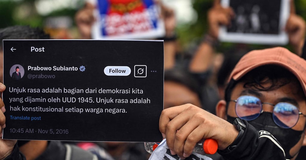 Indonesian students display posters with a tweet of President Prabowo Subianto reading “rallies are part of democracy guaranteed by law” during a protest against a revision to the armed forces law in Surabaya on Tuesday. Photo: AFP
