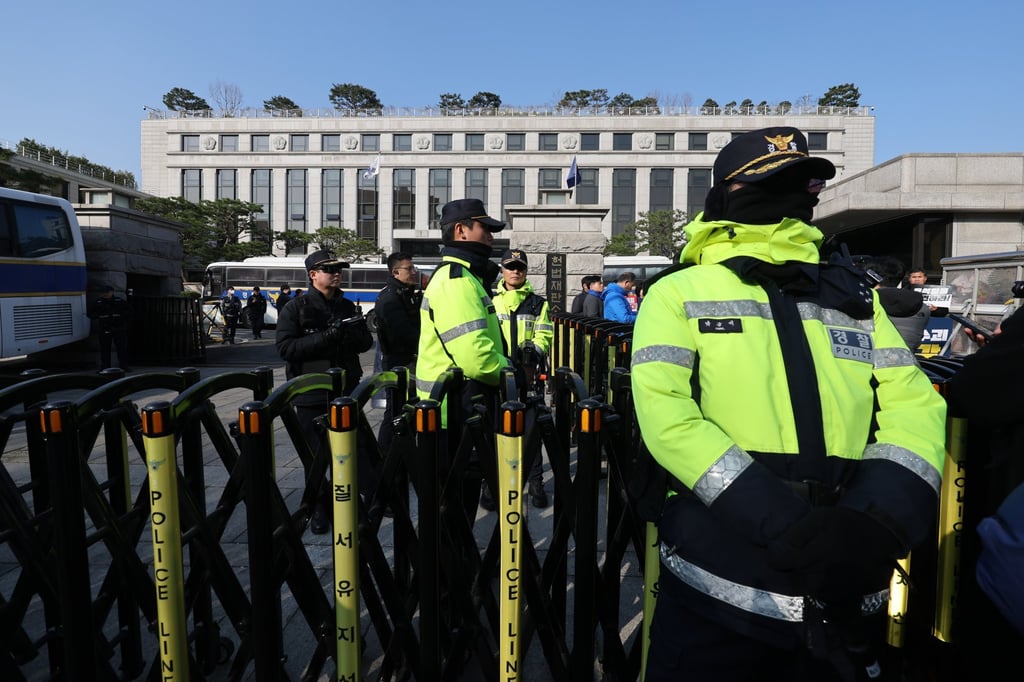 Police officers stand guard at the Constitutional Court in Seoul on Monday. Photo: Yonhap/EPA-EFE