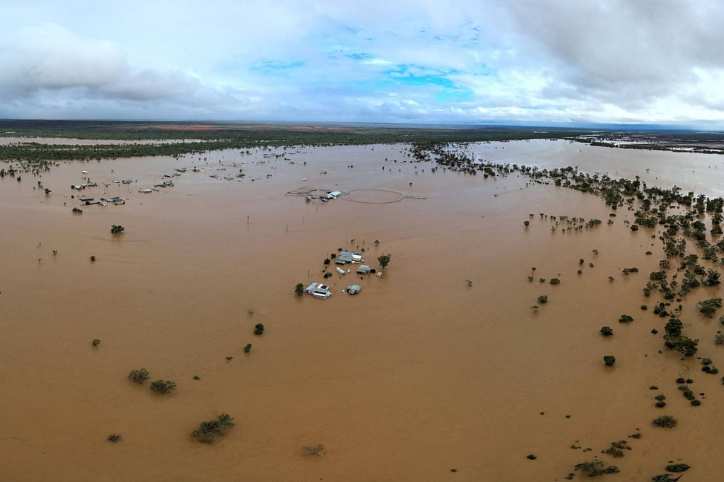 Homes under floodwaters in Queensland. Whole herds of cattle have drowned in vast inland floods seeping across the Australian outback as the muddy tide drenched an area the size of Texas. Photo: Queensland Fire Department/AFP
