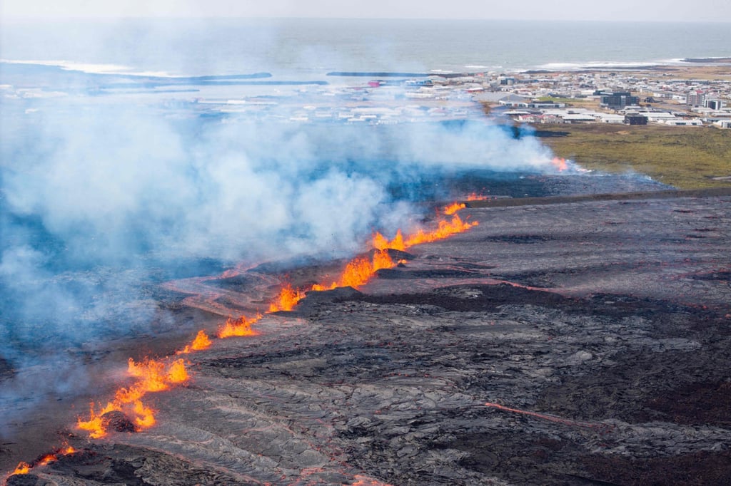 Molten lava is seen coming out of a fissure on the outskirts of the fishing village of Grindavik in southwest Iceland on Tuesday. Photo: AFP