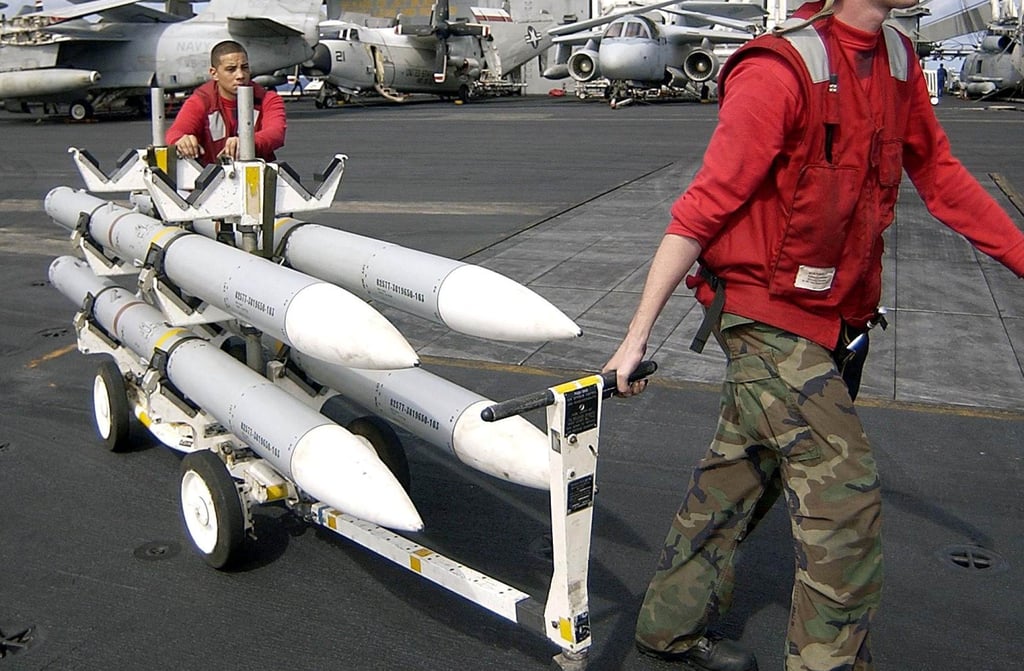 A skid of Advanced Medium-Range Air to Air Amraam (AIM-120) missiles being transported aboard a US aircraft carrier. Photo: US Navy/AFP