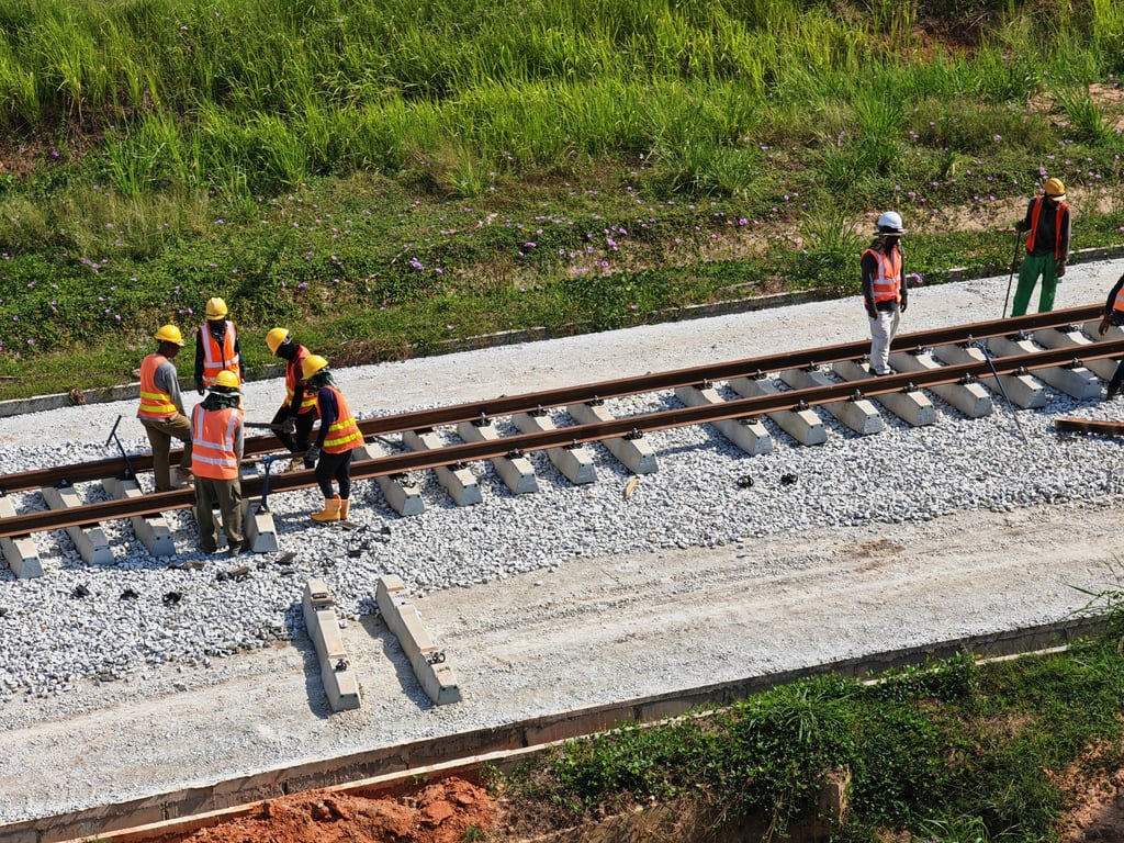 Workers lay railway sleepers for a branch line linking Perlis Inland Port to peninsula Malaysia’s West Coast railway. Photo: Joseph Sipalan
