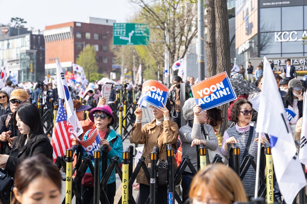 Supporters of Yoon Suk-yeol hold “Yoon Again” signs in Seoul, South Korea, on Friday. Photo: Kim Jung-yeop