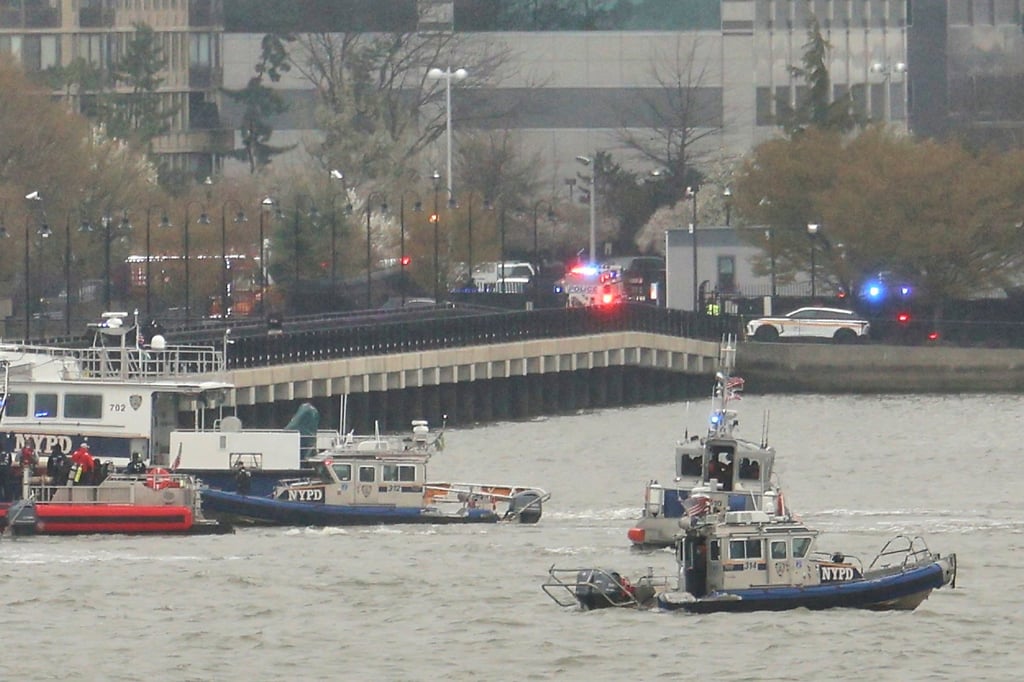 Police and fire crews from New York and New Jersey respond to the scene of a helicopter crash on Thursday. Photo: AP