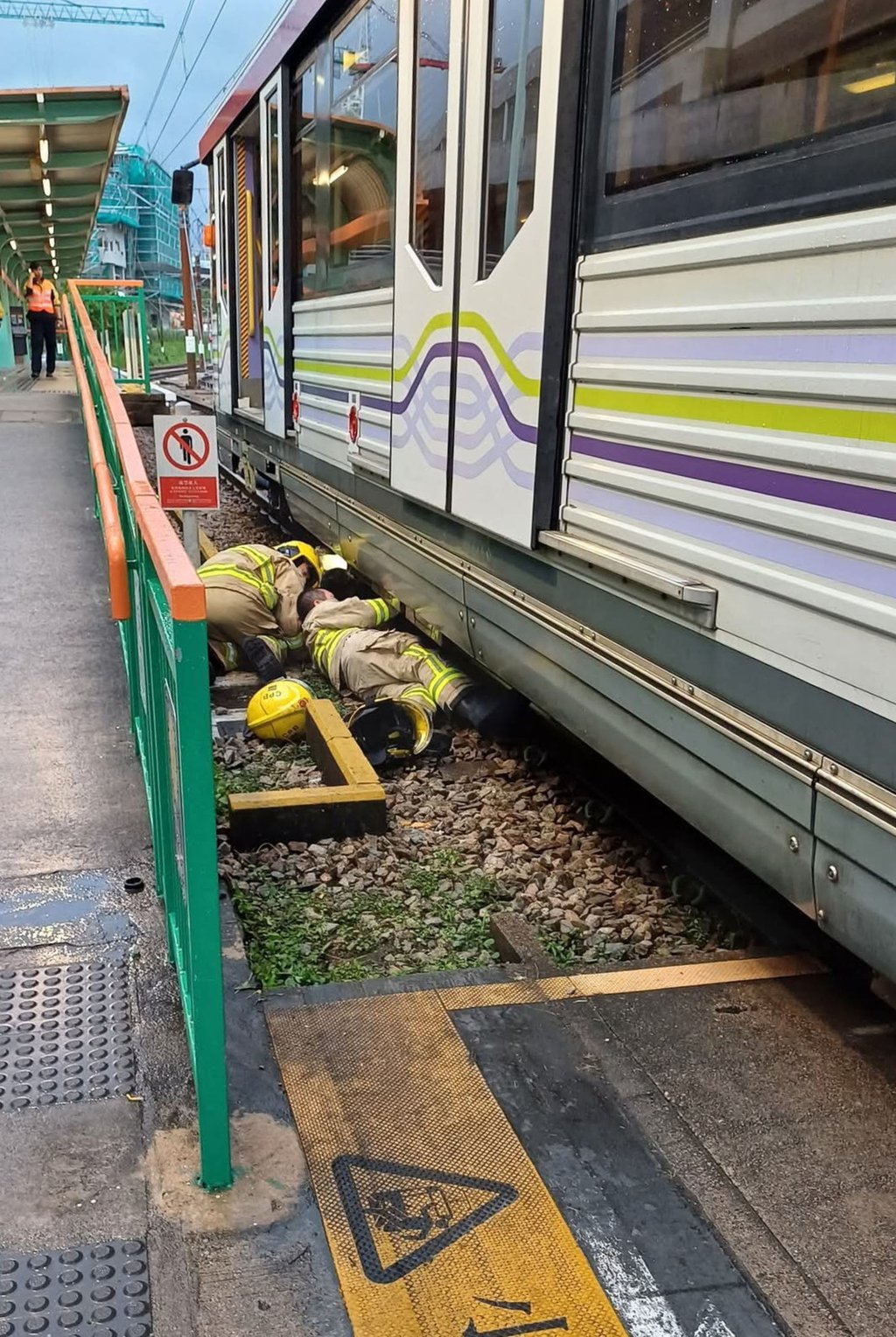 The woman had to be rescued by firefighters after being trapped underneath the train. Photo: Facebook/Adolf Cheung