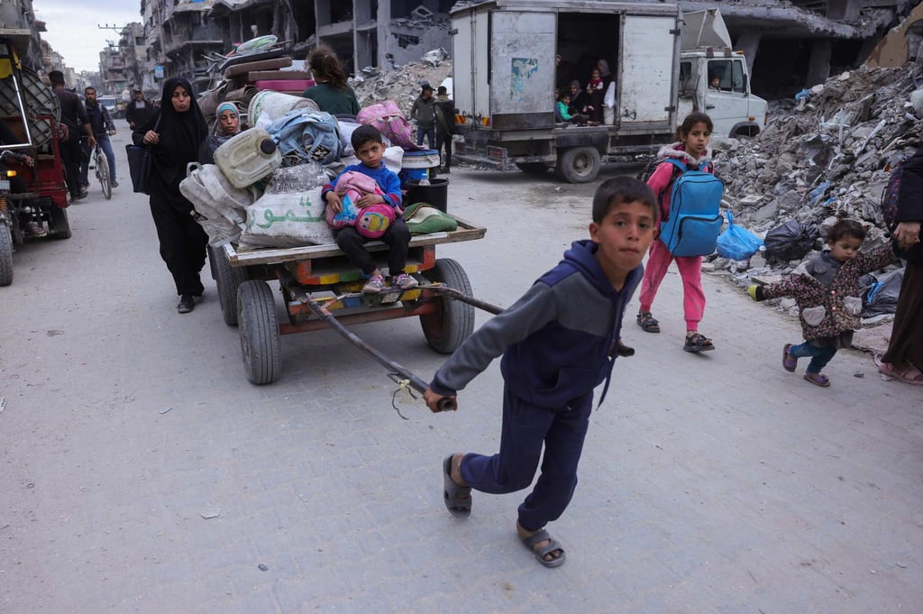 Palestinians ferry their belongings as they arrive in Gaza City to flee neighbourhoods to the east of the city following Israeli evacuation orders on Friday. Photo: AFP