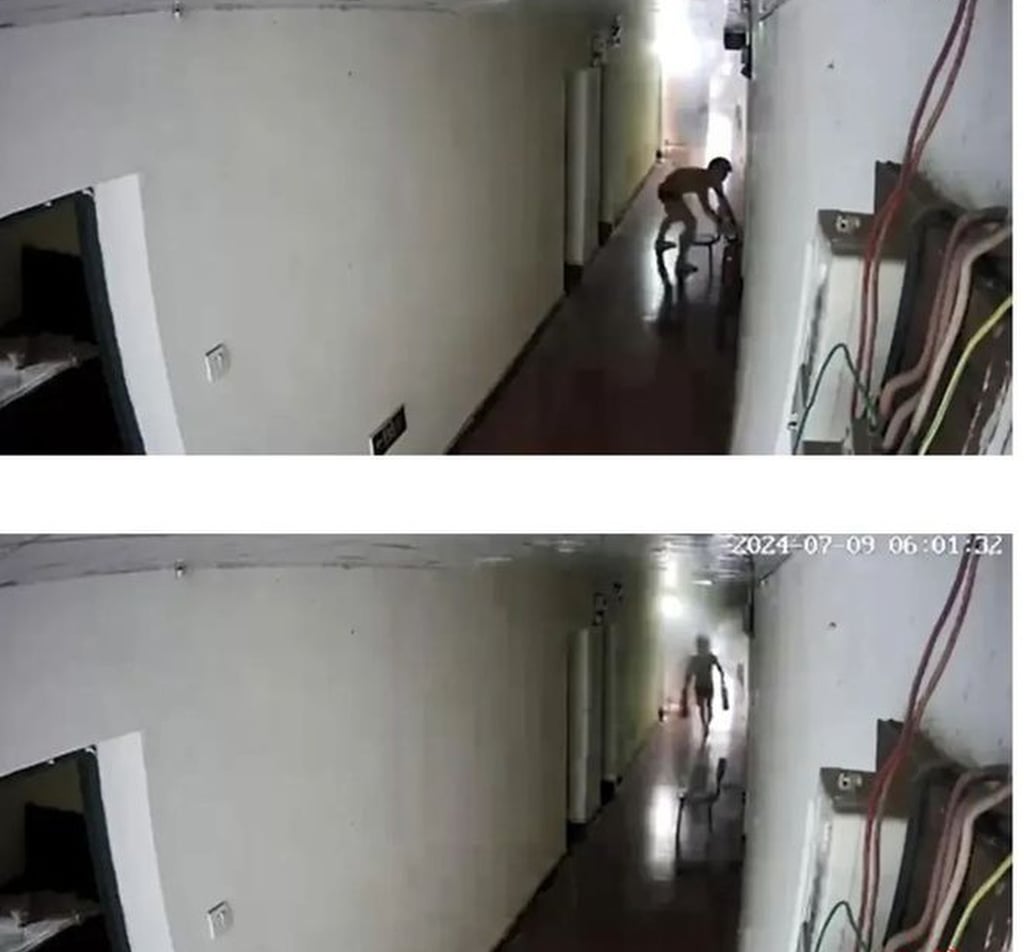 Surveillance video footage shows Li Jiajun grabbing fire extinguishers in the smoke-filled corridor outside the flat. Photo: 163.com