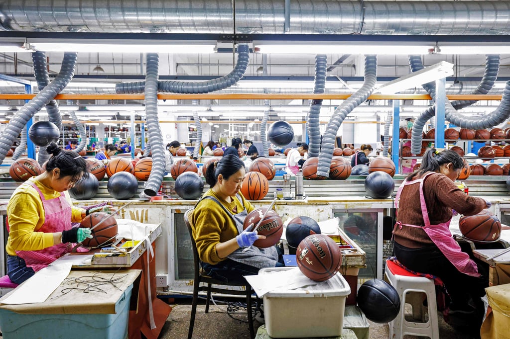 Workers produce basketballs for export in Sihong in China’s Jiangsu province, on March 25. Photo: AFP