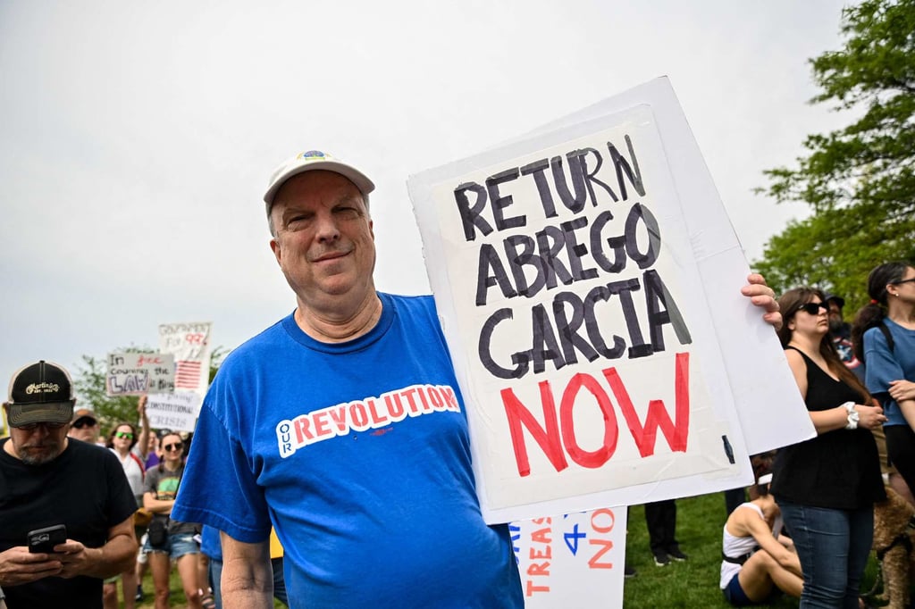 Protesters hold signs as they march towards the White House during a ‘Free Kilmar Abrego Garcia’ and anti-Trump rally in Washington on Saturday. Administration officials have claimed Abrego Garcia he is an illegal migrant, a gang member and involved in human trafficking without providing evidence. Photo: AFP