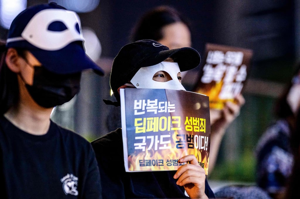 Activists wearing masks protest against deepfake porn in Seoul last year. The poster reads: “Repeated deepfake sex crimes, the state is an accomplice too.” Photo: AFP