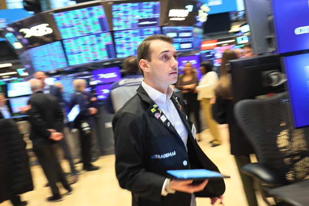 Traders work on the floor of the New York Stock Exchange on Tuesday. Photo: AFP