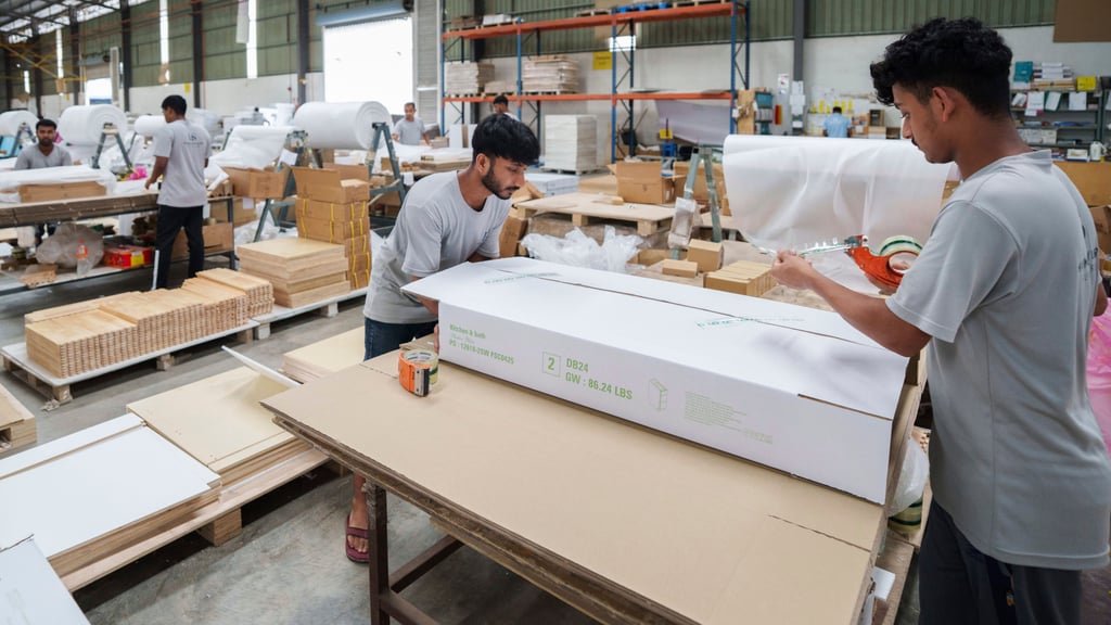Workers pack furniture for shipping to the US at a factory in Johor, Malaysia, on April 11. Photo: AP