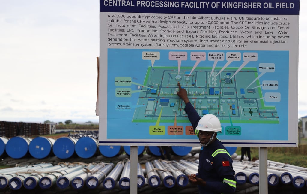 A worker shows a map of the Kingfisher Oilfield’s central processing facility in Kikube, Uganda. Photo: Xinhua
