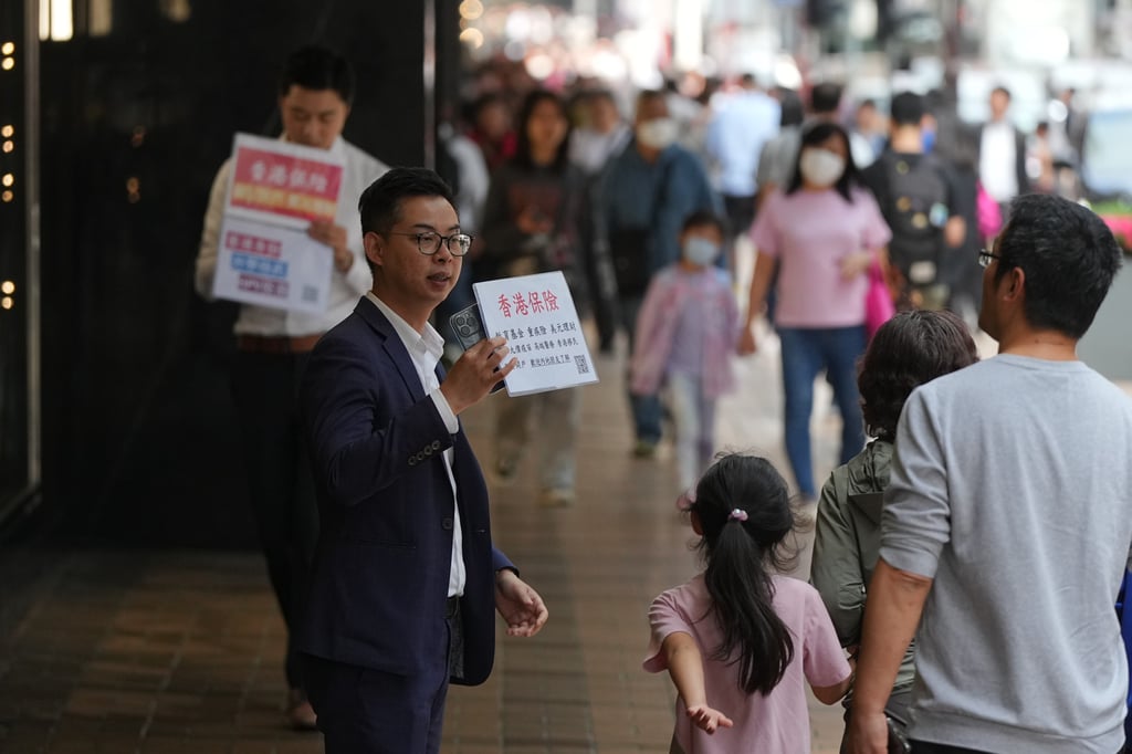 An insurance sales agent touting to mainland tourists in Canton Road, Tsim Sha Tsui on 20 February 2024. Photo: Eugene Lee