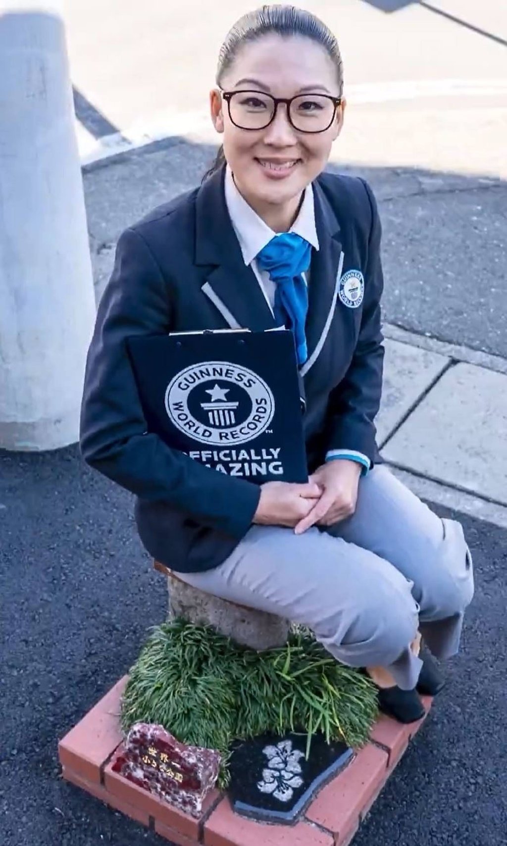 A Guinness World Records representative sits on the single stool in the world’s smallest park in Nagaizumi town, Japan. Photo: X/GWR
