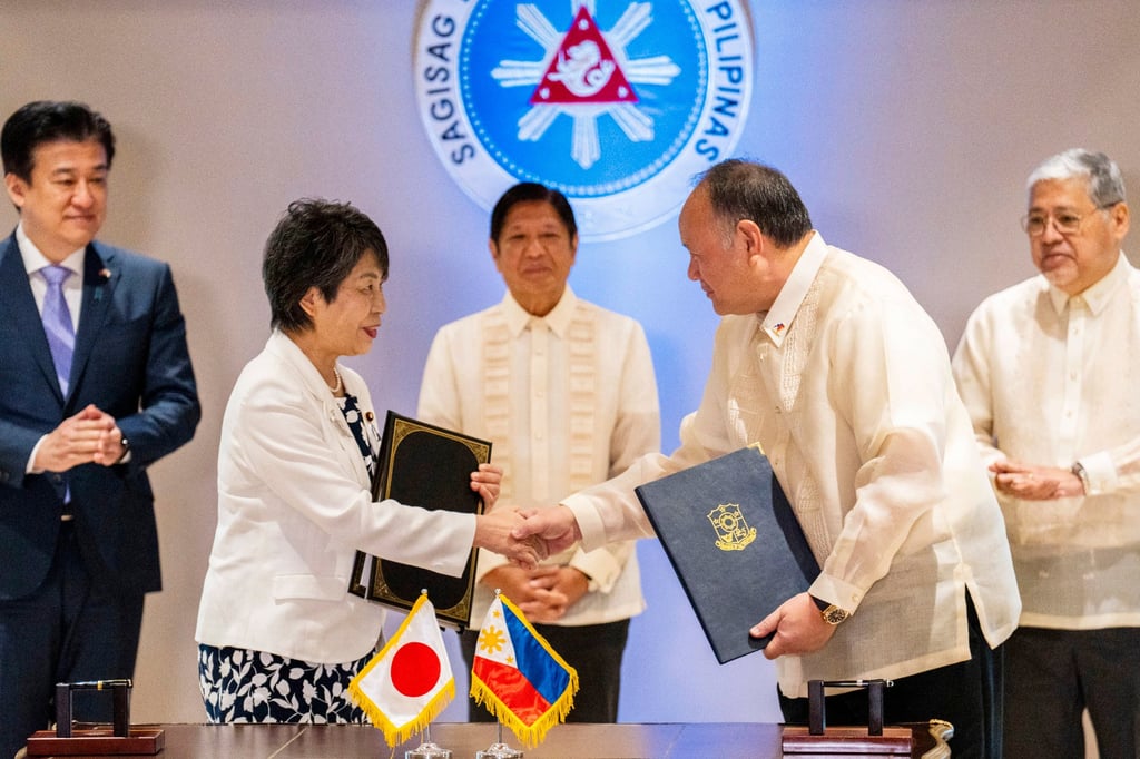 Japan Foreign Minister Yoko Kamikawa and Philippine Defence Secretary Gilberto Teodoro shake hands after signing a Reciprocal Access Agreement in Manila on July 8, 2024. Photo: AP