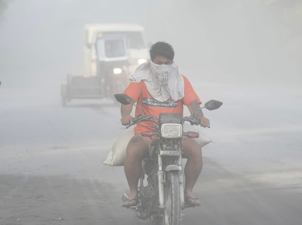 Motorists manoeuvre along a road covered with volcanic ash from the Bulusan Volcano, in Sorsogon province, the Philippines, on Monday. Photo: Sorsogon Provincial Information Office/EPA-EFE