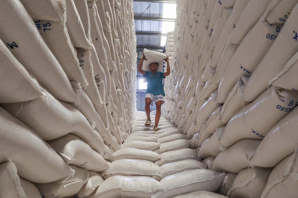 A worker carries a sack of rice inside the National Food Authority warehouse in Metro Manila. Rice is a staple in the Philippines, and households were badly hit when prices surged to a 15-year-high in 2024. Photo: Xinhua