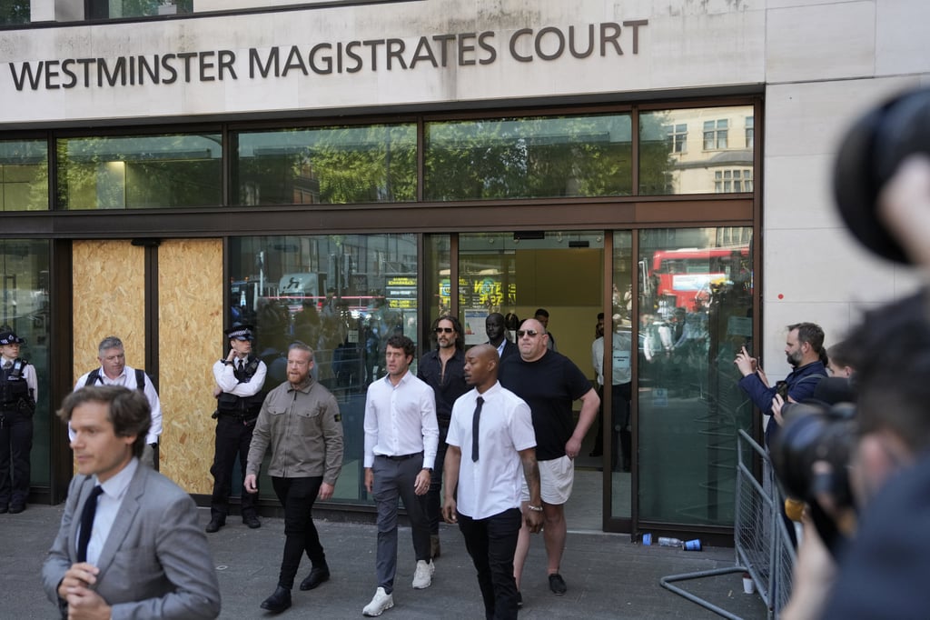 Russell Brand leaves Westminster Magistrates’ Court in London. He faces one count of rape, one of indecent assault, one of oral rape and two of sexual assault. Photo: Reuters