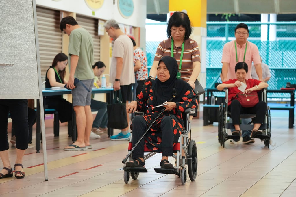 Singaporean voters arrive at a polling station on Saturday. Photo: AP