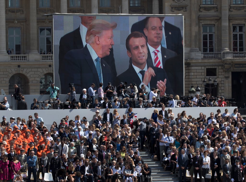 US President Donald Trump and French President Emmanuel Macron are seen on screen during the Bastille Day parade on the Champs Elysees avenue in Paris in July 2017. Photo: AP