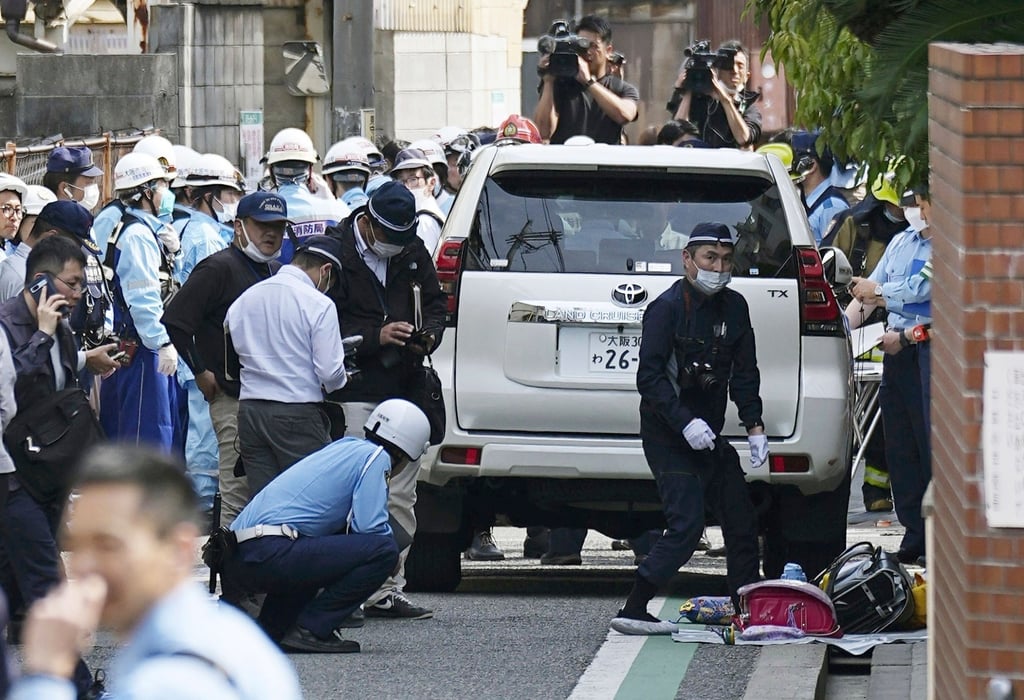 Police officers inspect the vehicle used in the attack in Osaka on Thursday. Photo: Kyodo News via AP