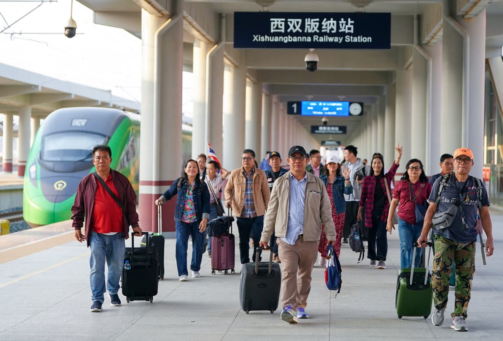 Tourists from Laos and Thailand arrive at a railway station in Jinghong, southwest China’s Yunnan province, in February. Photo: Xinhua